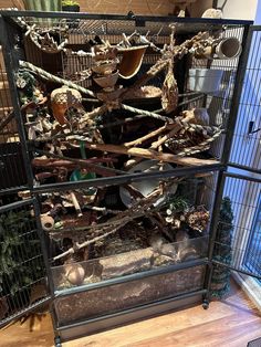 a cage filled with lots of different types of birds