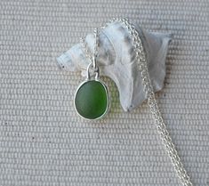 Green sea glass sterling silver necklace. This lovely piece of sea glass was collected by me at the famous Seaham beach. The sea glass is set in a sterling silver bezel and the chain is sterling silver and is 18 inches long. Please let me know if you would like a different chain length - I'd be happy to arrange it at no extra cost. Each piece of sea glass I use in my jewellery is beautifully frosted and carefully selected for the design based on colour, size and shape. They are shaped and frosted by the sea and time only. I pour my heart into the jewellery I make and I hope you will treasure it as much as I treasure creating it. This necklace is packaged in a white organza bag and tissue paper and is ready to be given as a gift. If you require any further information please contact me. Tha Seaham Beach, Glass Jewellery, Sea Glass Pendant, Necklace Green, Sea Glass Necklace, Green Sea, Sea Glass Jewelry, Necklace Sterling Silver, Glass Necklace