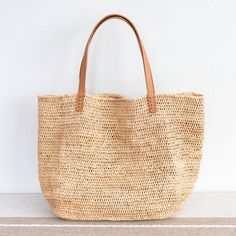 Chic large straw woven tote bag perfect for all occasions. This tote bag is sure to keep up with your busy lifestyle, providing a lightweight and durable design with a classic aesthetic. It’s the perfect way to stay organized while making a stylish statement. Natural Soft Raffia Straw Genuine leather handlesNo linerDimensions: 14"H x 20"W x 8.5"D10" handle drop Designer Style ID: 8583 Large Straw Woven Tote Bag, Summer Bag, Everyday Shoulder Bag, Beach Bag Beige Straw Bag With Rolled Handles, Natural Beach Bag With Rolled Handles For Daily Use, Daily Use Straw Beach Bag With Rolled Handles, Eco-friendly Straw Travel Bag With Rolled Handles, Natural Color Rectangular Crochet Bag With Rolled Handles, Rectangular Natural Crochet Bag With Rolled Handles, Natural Rectangular Crochet Bag With Rolled Handles, Rectangular Straw Bucket Bag With Rolled Handles, Straw Beach Bag With Rolled Handles