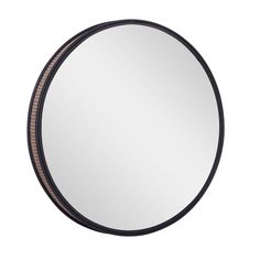 a round mirror on a white wall with a black frame and brown trim around the edges