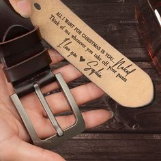 a person holding a belt with a message on it