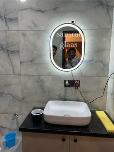 a bathroom sink with a mirror above it and a hair dryer on the counter