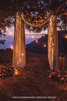 an outdoor wedding setup with lights and flowers