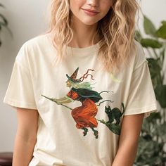 ✨ Flaunt your unique style with our aesthetic tees! This selfie-worthy design is printed with eco-friendly inks on the garment-dyed 100% cotton Comfort Colors t-shirt, an oversized top that feels like a well-worn favorite the moment you put it on. ✨ SIZING * Please refer to the size chart in the listing photos for exact measurements. * Better yet, simply lay out your favorite t-shirt and measure it, comparing it to our size chart. * This is a relaxed fit unisex sized shirt, which means that thos Vintage Crew Neck Halloween Tops, Fall Goblincore Crew Neck T-shirt, Vintage Crew Neck Tops For Halloween, Spooky Cotton Shirt With Screen Print, Goblincore Graphic Print Short Sleeve T-shirt, Witchy Short Sleeve Cotton Tops, Witchy Cotton Short Sleeve Tops, Halloween Goblincore T-shirt With Graphic Print, Goblincore Halloween Short Sleeve T-shirt