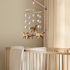 a baby crib with some toys hanging from it