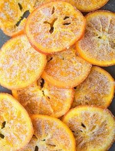 sliced oranges sitting on top of a black plate