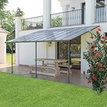 a white house with a patio and picnic table