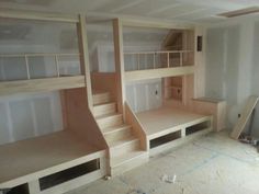 an empty room with bunk beds and stairs