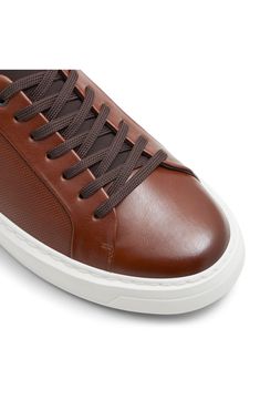 Microscopically perforated paneling and colorblocked accents update the classic design of this low-profile sneaker boasting a water-resistant finish. Lace-up style Water resistant Synthetic and textile upper and lining/rubber sole Imported Leather Mid-top Skate Shoes With Perforations, Modern Brown Sneakers For Sports, Brown Leather Low-top Skate Shoes, Sporty Brown Slip-on Sneakers With Textured Sole, Sporty Brown Slip-on Sneakers, Brown Sporty Slip-on Sneakers Synthetic, Sporty Brown Synthetic Slip-on Sneakers, Classic Brown Sneakers With Textured Sole, Custom Low-top Synthetic Sneakers With Perforations