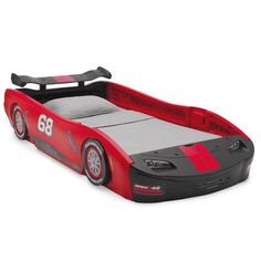 a red and black car shaped bed with the number 38 on it's side