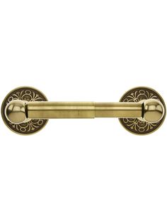 an antique style brass door handle with decorative designs on the front and back ends,