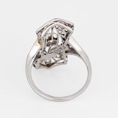 Finely detailed antique Edwardian ring (circa 1900s to 1910s) crafted in 900 platinum.   Centrally mounted estimated 0.25 carat old Mine cut diamond is accented with 18 x estimated 0.02 to 0.03 carat diamonds. The total diamond weight is estimated at 0.63 carats. The diamonds are estimated at H-I colour and SI1-2 clarity.   The ring features lacy filigree detail within an elongated shield mount, a hallmark of the Edwardian era. With a slight curved saddle the ring sits comfortably on the finger Antique Platinum Diamond Ring With Diamond Accents, Victorian White Gold Diamond Ring, Victorian Diamond Ring In White Gold, Formal Art Nouveau Diamond Jewelry, Victorian Platinum Diamond Ring With Single Cut Diamonds, Art Deco Platinum Rings With Single Cut Diamonds, Elegant Formal Cluster Ring With Intricate Design, Art Deco Oval Platinum Diamond Ring, Art Deco Platinum Ring With Single Cut Diamonds