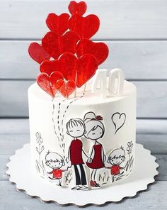 a white cake with red hearts on top