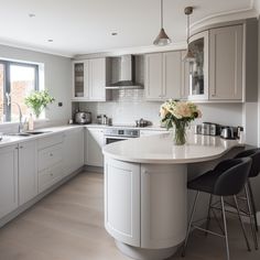 a large kitchen with an island in the middle and lots of counter space on one side