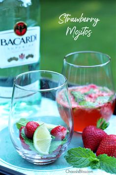 strawberry mojits in glasses with mint and lime garnish on the side