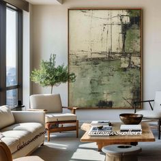 a living room filled with furniture and a large painting on the wall above it's windows