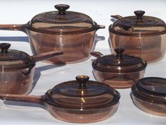 a group of brown pots and pans sitting on top of a table