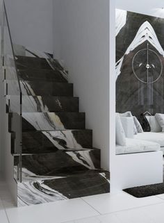 a living room filled with white furniture next to a stair case covered in black and white marble