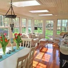 the sun room is clean and ready to be used for dining or living rooms with wood flooring