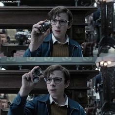 harry potter holding up a camera in front of his face and looking at the mirror