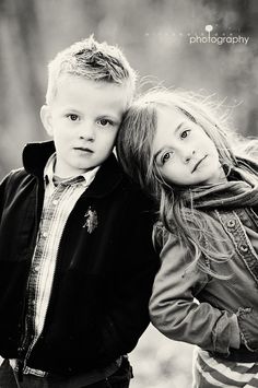 black and white photograph of two children posing for the camera with their arms around each other