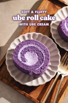 two white plates topped with purple cake on top of a wooden cutting board next to a knife and fork