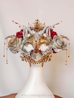 Ivory cat skull mask with golden filigree metal elements, red roses, and red rhinestones. Perfect for cosplay, costume parties, and Gothic fashion. Cat Skull Mask, Animal Masquerade Mask, Fantasy Masquerade, Masquerade Ball Costume, Masquerade Ball Gown, Mask Masquerade, Cat Skull, Concept Clothing, Skull Mask