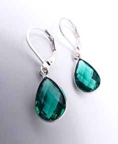 "Simply Gorgeous!  These elegant lightweight drop dangle earrings feature dainty faceted emerald green teardrop petite crystals on genuine 925 sterling silver leverback hooks.  Dainty Faceted Emerald Green Crystal / 925 Sterling Silver MEASURES:  16mm Wide  x  1 1/8\" Long TEARDROP CRYSTAL:  7mm Wide  x  16mm Long 925 STAMPED STERLING SILVER LEVER BACK HOOK ☆ Specifications: * Dainty Faceted Emerald Green Teardrop Crystals * Approximate size  16mm Wide  x  1 1/8\" Long * 925 Sterling Silver Hooks ☆ FREE SHIPPING WITHIN THE USA VIA USPS FIRST CLASS MAIL.  INTERNATIONAL SHIPPING IS ONLY $16.95 USD VIA USPS FIRST CLASS EXPEDITED INTERNATIONAL MAIL SERVICE. ☆ THANKS FOR LOOKING! ☆" Green Teardrop Dangle Earrings For Everyday Wear, Everyday Green Dangle Teardrop Earrings, Everyday Green Teardrop Dangle Earrings, Emerald Green Crystal, Leverback Earrings, Earrings Minimalist, Green Crystal, Green Crystals, Sterling Silber