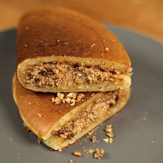 two pieces of bread on a plate with granola toppings and nuts in the middle