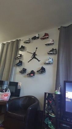 a living room filled with lots of shoes hanging on the wall next to a tv