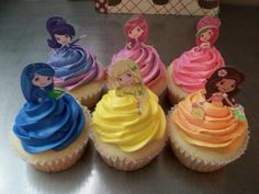 some cupcakes with different colored frosting on them