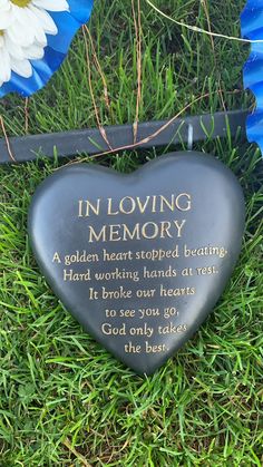 a heart shaped memorial sitting in the grass