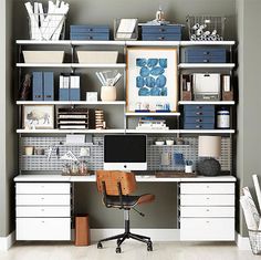 a desk with a computer on top of it in front of a bookshelf