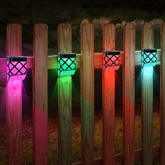 colorful lights are lit up on wooden posts