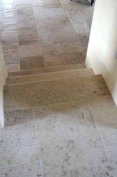 an open door leading to a bathroom with tile flooring