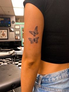 a woman with a butterfly tattoo on her arm