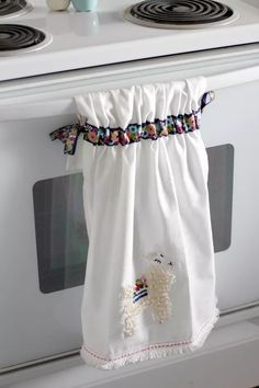 a white oven with a towel hanging from it's front and two burners in the back