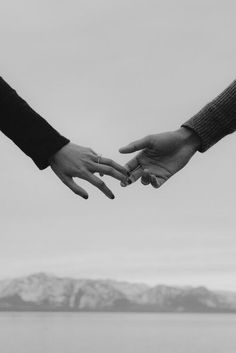 black and white photograph of two people holding hands