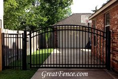 an iron gate in front of a brick house