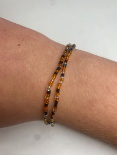 This is an orange, black, and clear seed bracelet. Seed bead means that is a very small bead. The bracelet is made with extra stretch string, so it fits most all sizes. If you have any questions about sizes or anything's please message me! This bracelet/'s could be great for any Halloween party or just some extra fall style Orange Halloween Gift Bracelet, Cheap Orange Halloween Bracelets, Pumpkin Bead Bracelet, Spooky Bracelet, Edgy Halloween Bracelet, Fall Bracelets, Autumn Bracelet, Halloween Bracelet, Fete Halloween