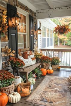 a porch decorated for fall with pumpkins and gourds