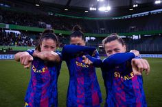 three female soccer players are posing for the camera