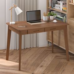 a laptop computer sitting on top of a wooden desk in front of a book shelf