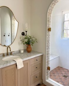 a bathroom with a sink, mirror and bathtub