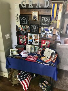 a table with pictures and other items on it in front of a sign that reads grad