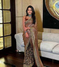 a woman in a sari posing for the camera