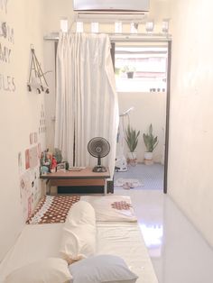 a living room with white walls and curtains