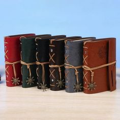 a row of leather bound notebooks tied with twine and decorated with cross decorations