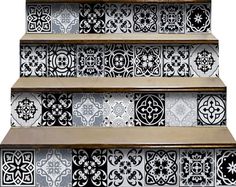 a set of stairs painted with black and white tile designs on the bottom part of each step