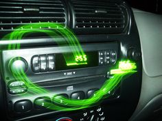 an image of a car radio with green lights on it's dash board and buttons